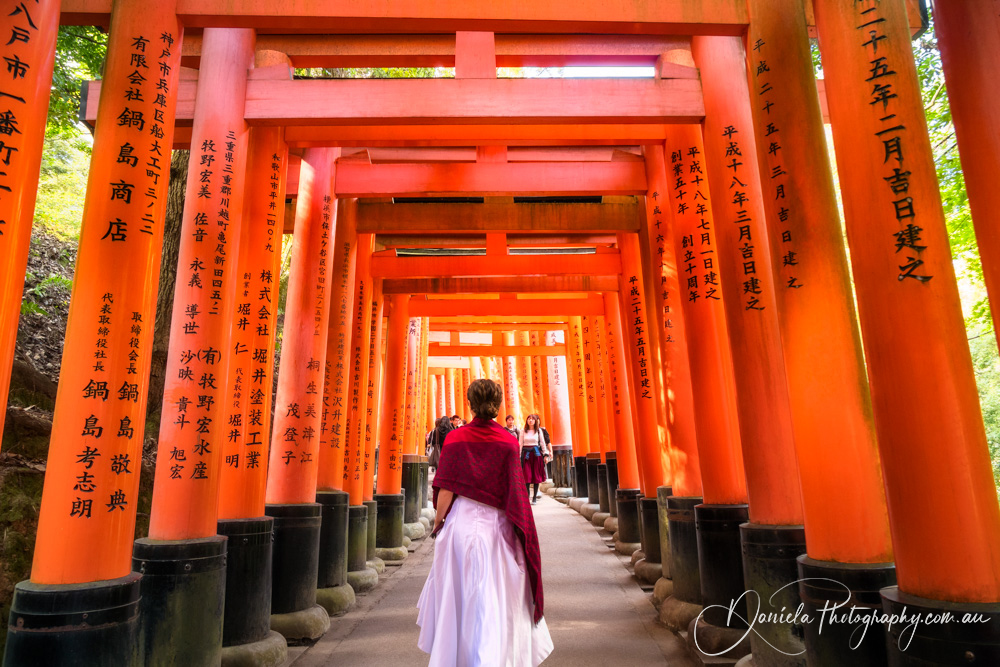 Kyoto Young Lady walking through Senbon Torii at Fushimi Inari Shrine